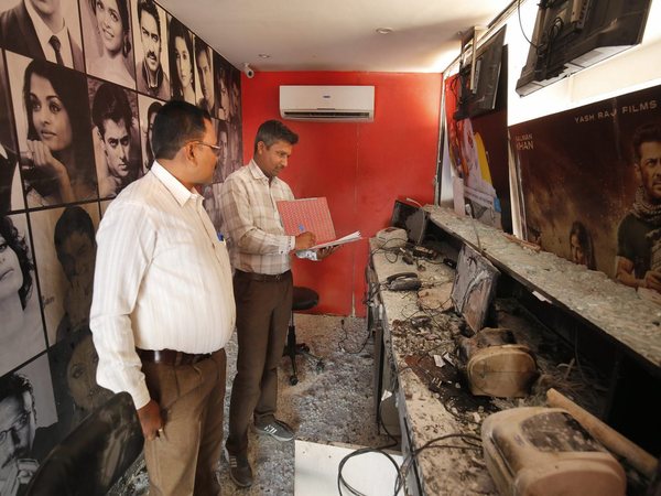 Forensic experts examine the ticket counter of a cinema hall after it was vandalised in Ahmedabad Forensic experts examine the ticket counter of a cinema hall after it was vandalised in Ahmedabad