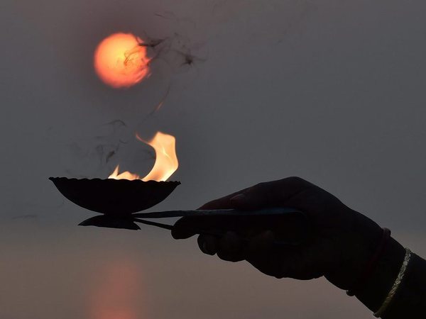 A devotee offering evening prayers to the Sun on the occasion of 'Makar Sankranti' at Gangasagar (Sagar Island) on Sunday. PTI Photo A devotee offering evening prayers to the Sun on the occasion of 'Makar Sankranti' at Gangasagar (Sagar Island) on Sunday. PTI Photo