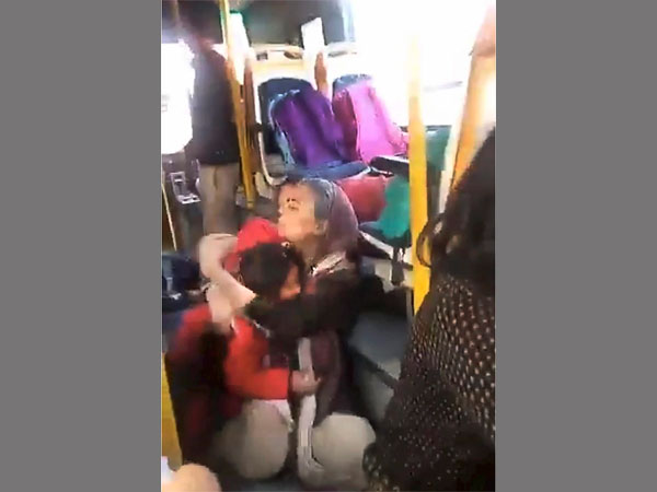 A woman hugs a child crouched on the floor of the GD Goenka World School bus, as a mob protesting against the film 'Padmaavat' threw stones at their bus in Gurugram. PTI photo A woman hugs a child crouched on the floor of the GD Goenka World School bus, as a mob protesting against the film 'Padmaavat' threw stones at their bus in Gurugram. PTI photo