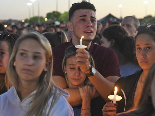 Mourners gather at a vigil that was held for the victims of the shooting at Marjory Stoneman Douglas High School, Thusday, Feb. 15, 2018, in Parkland, Fla. The teenager accused of using a semi-automatic rifle to kill more than a dozen people and injuring others at a Florida high school confessed to carrying out one of the nation's deadliest school shootings and concealing extra ammunition in his backpack, according to a sheriff's department report released Thursday. PTI photo Mourners gather at a vigil that was held for the victims of the shooting at Marjory Stoneman Douglas High School, Thusday, Feb. 15, 2018, in Parkland, Fla. The teenager accused of using a semi-automatic rifle to kill more than a dozen people and injuring others at a Florida high school confessed to carrying out one of the nation's deadliest school shootings and concealing extra ammunition in his backpack, according to a sheriff's department report released Thursday. PTI photo