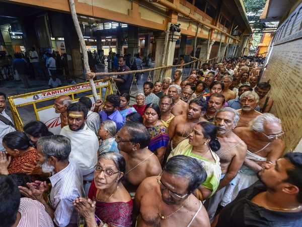 People wait in long queue