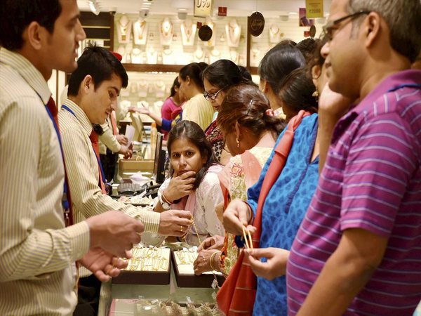 People buy jewelleries in a shop in New Delhi