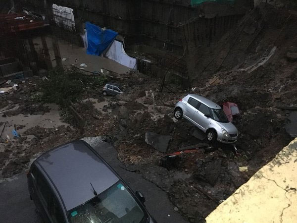 Cars were damaged after wall of an under construction building collapsed on Vidyalankar road in Mumbai. Courtesy: ANI news Cars were damaged after wall of an under construction building collapsed on Vidyalankar road in Mumbai. Courtesy: ANI news