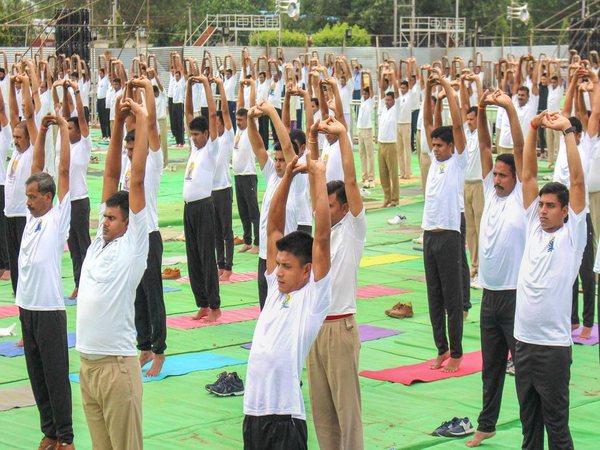 Students perform yoga ahead of International Day of Yoga 2018 at Lal Parade Ground, in Bhopal