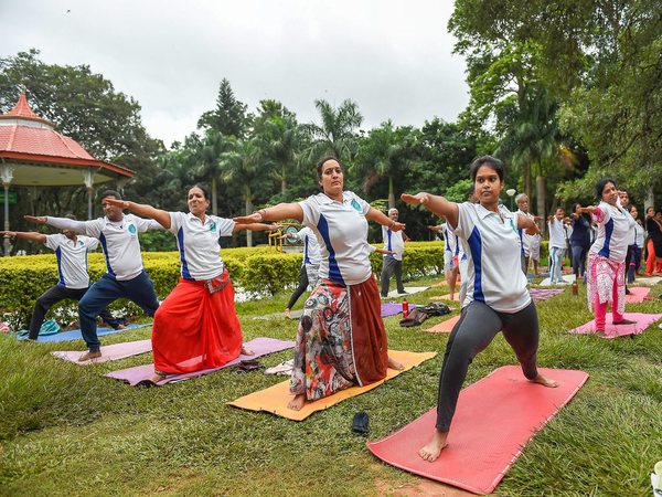 Yoga enthusiasts practice yoga on the eve of International Day of Yoga 2018 in Bengaluru