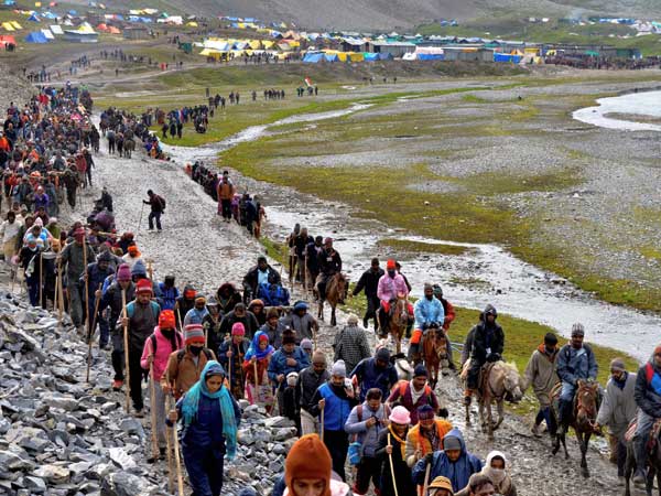 Pilgrims cross mountain trails during their religious journey to the Amarnath cave temple at Pahalgam in Anantnag district