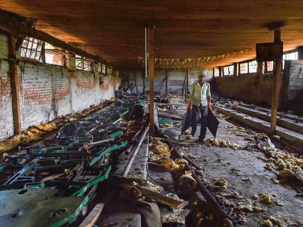 A labourer works inside the 100-year old closed filature