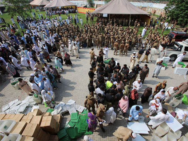 Election staff gather at a distribution center to receive polling material for elections, in Peshawar, Pakistan Election staff gather at a distribution center to receive polling material for elections, in Peshawar, Pakistan