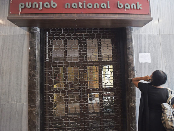 A woman looks on as CBI team seals Punjab National Bank’s South Mumbai branch at Brady House in Mumbai on Monday. The PNB fraud case involving jeweller Nirav Modi was allegedly carried out of this branch. A woman looks on as CBI team seals Punjab National Bank’s South Mumbai branch at Brady House in Mumbai on Monday. The PNB fraud case involving jeweller Nirav Modi was allegedly carried out of this branch.