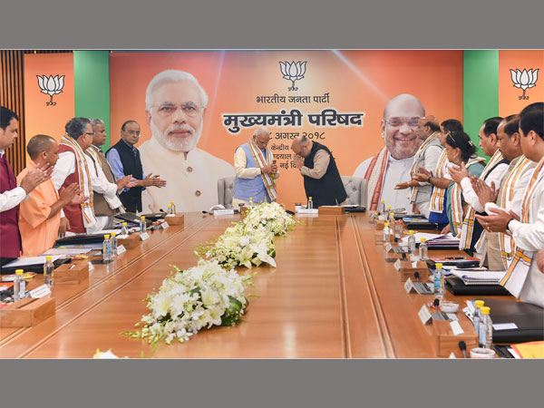 Prime Minister Narendra Modi being welcomed by BJP president Amit Shah as other leaders clap, during a day-long meeting of the BJP Chief Ministers Council in New Delhi Prime Minister Narendra Modi being welcomed by BJP president Amit Shah as other leaders clap, during a day-long meeting of the BJP Chief Ministers Council in New Delhi