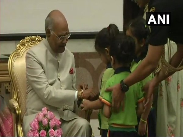 Children tie Rakhi to President Kovind