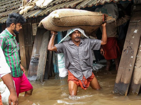 A person carries a grain sack as his house gets flooded after Kakkayam dam was opened following heavy monsoon rainfall, in Kozhikode. PTI file photo A person carries a grain sack as his house gets flooded after Kakkayam dam was opened following heavy monsoon rainfall, in Kozhikode. PTI file photo