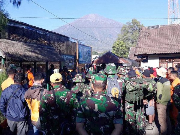 In this July 30, 2018, file photo, Indonesian soldiers and rescue team gather to prepare for evacuating tourists from Mount Rinjani, seen in the background, at Sembalun in East Lombok, Indonesia. A strong earthquake jolted the Indonesian island of Lombok on Sunday, Aug. 19, 2018, causing landslides on Mount Rinjani and damaging buildings, as it tries to recover from a temblor earlier this month that killed 460 people. AP/PTI photo In this July 30, 2018, file photo, Indonesian soldiers and rescue team gather to prepare for evacuating tourists from Mount Rinjani, seen in the background, at Sembalun in East Lombok, Indonesia. A strong earthquake jolted the Indonesian island of Lombok on Sunday, Aug. 19, 2018, causing landslides on Mount Rinjani and damaging buildings, as it tries to recover from a temblor earlier this month that killed 460 people. AP/PTI photo