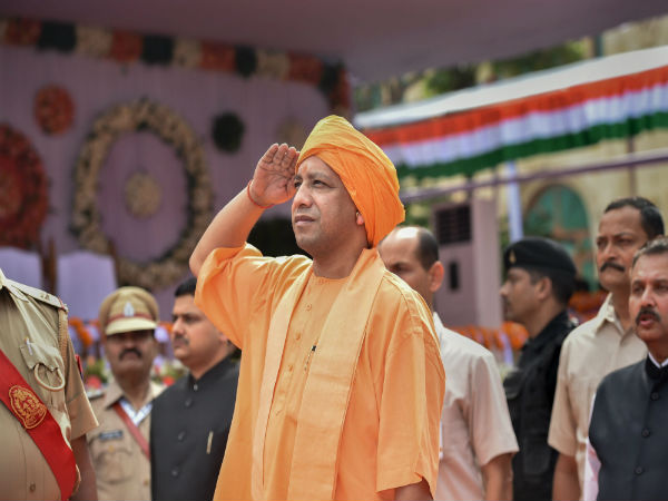 Yogi Adityanath salutes the national flag after hoisting it