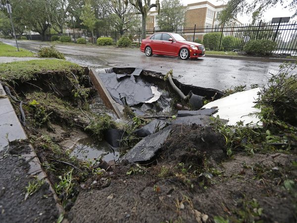 A car travels past a sinkhole in downtown Wilmington, N.C., after Hurricane Florence traveled through the area (Image credit - PTI) A car travels past a sinkhole in downtown Wilmington, N.C., after Hurricane Florence traveled through the area (Image credit - PTI)