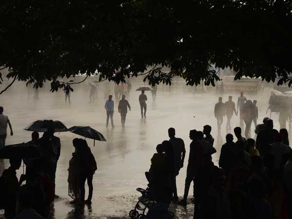 People protect themselves with umbrellas during rains People protect themselves with umbrellas during rains