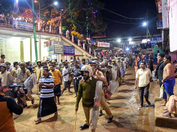 Police personnel detain devotees