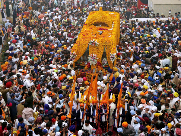 Sikh pilgrims attend a religious festival to celebrate the 549th birth anniversary of their spiritual leader Baba Guru Nanak, at Nankana Sahib near Lahore, Pakistan Sikh pilgrims attend a religious festival to celebrate the 549th birth anniversary of their spiritual leader Baba Guru Nanak, at Nankana Sahib near Lahore, Pakistan
