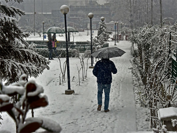 A man walks over a snow covered street during snowfall, in Srinagar, Friday, Jan. 04, 2019. PTI Photo A man walks over a snow covered street during snowfall, in Srinagar, Friday, Jan. 04, 2019. PTI Photo