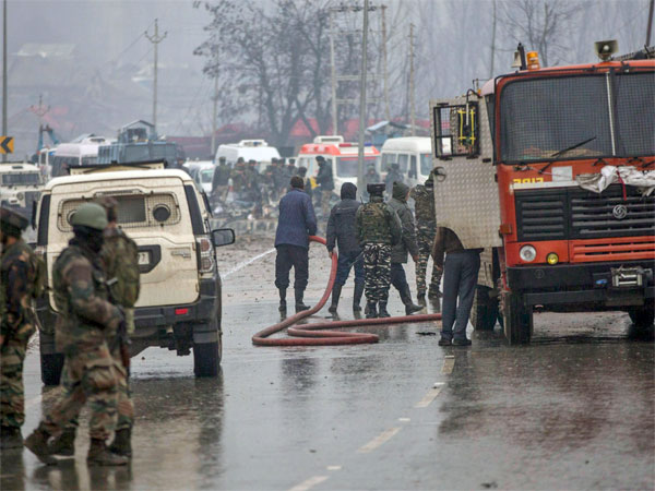 Firemen spray water on a road to wash away the blood stains at the site of suicide bomb attack at Lathepora Awantipora in Pulwama district of south Kashmir Firemen spray water on a road to wash away the blood stains at the site of suicide bomb attack at Lathepora Awantipora in Pulwama district of south Kashmir