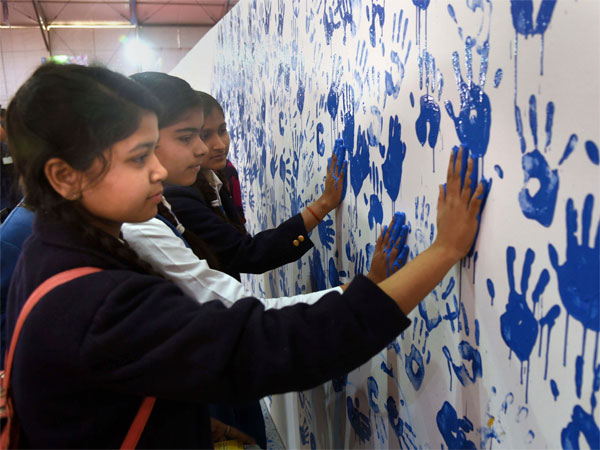 Girls leave their hand impressions on a canvas as Kumbh Mela 2019 administration attempts to create a painting with palm impressions of approximately 8000 people for a world record, at a camp in Prayagraj, Friday, March 1, 2019. (PTI Photo) Girls leave their hand impressions on a canvas as Kumbh Mela 2019 administration attempts to create a painting with palm impressions of approximately 8000 people for a world record, at a camp in Prayagraj, Friday, March 1, 2019. (PTI Photo)