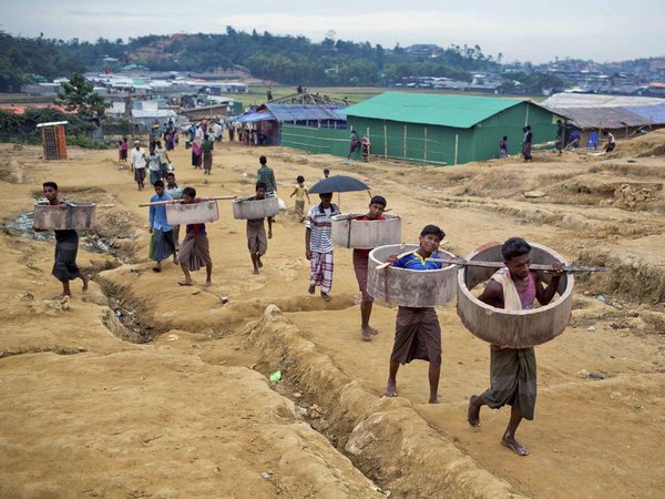 Rohingya Muslims, who crossed over from Myanmar into Bangladesh, carrying construction material and walk towards Jamtoli refugee camp in Ukhiya, Bangladesh, Friday, Nov. 17, 2017. PTI file photo Rohingya Muslims, who crossed over from Myanmar into Bangladesh, carrying construction material and walk towards Jamtoli refugee camp in Ukhiya, Bangladesh, Friday, Nov. 17, 2017. PTI file photo