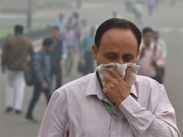 A pedestrian covers his face with a handkerchief for protection against air pollution, in New Delhi A pedestrian covers his face with a handkerchief for protection against air pollution, in New Delhi
