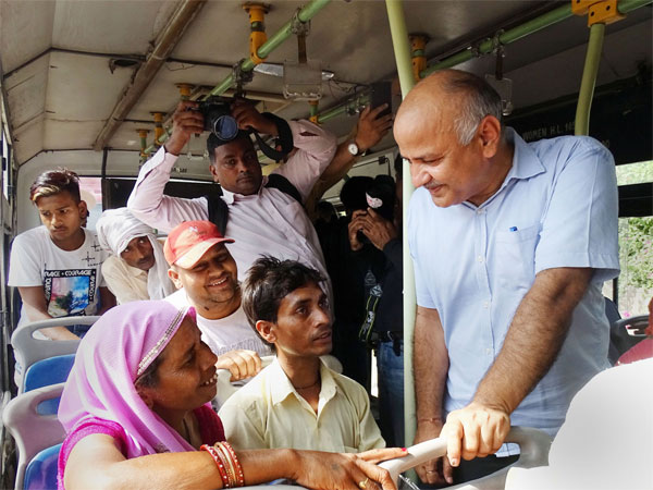 Delhi Deputy Chief Minister Manish Sisodia interacts with a woman passenger in a DTC bus, in New Delhi Delhi Deputy Chief Minister Manish Sisodia interacts with a woman passenger in a DTC bus, in New Delhi