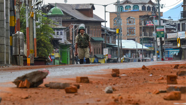 A security personnel stands guard during curfew like restriction on fifth consecutive day in Srinagar A security personnel stands guard during curfew like restriction on fifth consecutive day in Srinagar