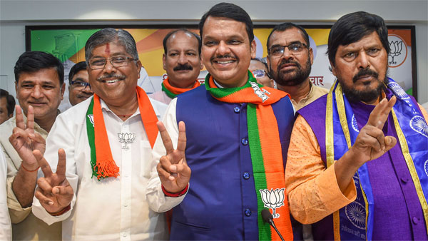 Maharashtra Chief Minister Devendra Fadnavis, State BJP president Chandrakant Patil and RPI chief Ramdas Athawale flash victory signs as they celebrate their win in Maharashtra Assembly elections, in Mumbai Maharashtra Chief Minister Devendra Fadnavis, State BJP president Chandrakant Patil and RPI chief Ramdas Athawale flash victory signs as they celebrate their win in Maharashtra Assembly elections, in Mumbai