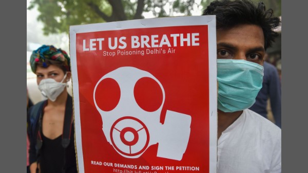 Members of DYFI and JSA (Delhi) wearing masks display placards during protest march Members of DYFI and JSA (Delhi) wearing masks display placards during protest march