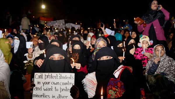 Muslim community women holds candle during a march against CAA, NRC at Jama Masjid: