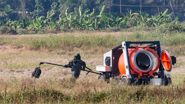 A bomb disposal squad member carries the suspicious bag, allegedly containing an IED component, for defusal, after it was found at the airport in Mangaluru A bomb disposal squad member carries the suspicious bag, allegedly containing an IED component, for defusal, after it was found at the airport in Mangaluru