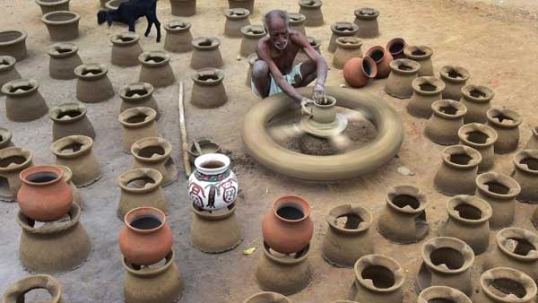 Potter engaged in making pots ahead of the Harvest festival 'Pongal' :