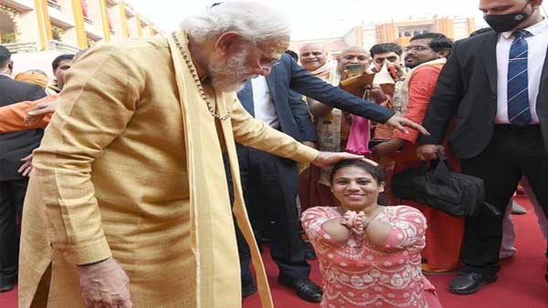PM Modi with a Divyang PM Modi with a Divyang