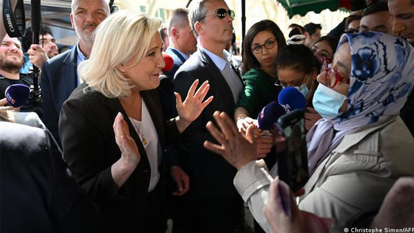 Macron, Le Pen lock horns over Islamic headscarf Macron, Le Pen lock horns over Islamic headscarf