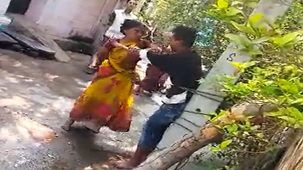 Women ties son to pole, rubs mirchi powder in his eyes in Viral video in Telangana Women ties son to pole, rubs mirchi powder in his eyes in Viral video in Telangana