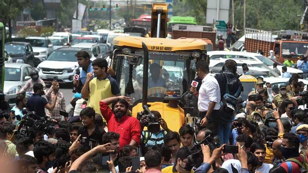 Locals stage a protest in front of a Municipal Corporation of Delhi (MCD) bulldozer at Shaheen Bagh area during an anti-encroachment drive, in New Delhi Locals stage a protest in front of a Municipal Corporation of Delhi (MCD) bulldozer at Shaheen Bagh area during an anti-encroachment drive, in New Delhi