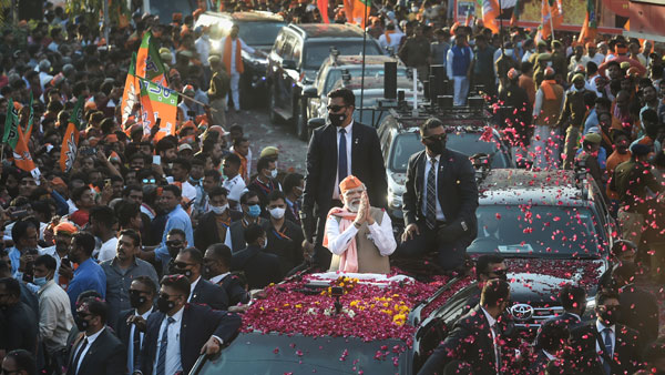 Prime Minister Narendra Modi greets supporters during a roadshow Prime Minister Narendra Modi greets supporters during a roadshow