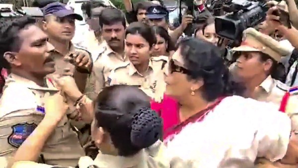 Senior Congress leader Renuka Chowdary holds a cops collar during a protest over Congress leader Rahul Gandhis questioning by the Enforcement Directorate in connection with the National Herald case, in Hyderabad Senior Congress leader Renuka Chowdary holds a cops collar during a protest over Congress leader Rahul Gandhis questioning by the Enforcement Directorate in connection with the National Herald case, in Hyderabad