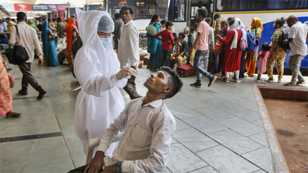 A health worker collects a swab sample of a man for COVID-19 test A health worker collects a swab sample of a man for COVID-19 test