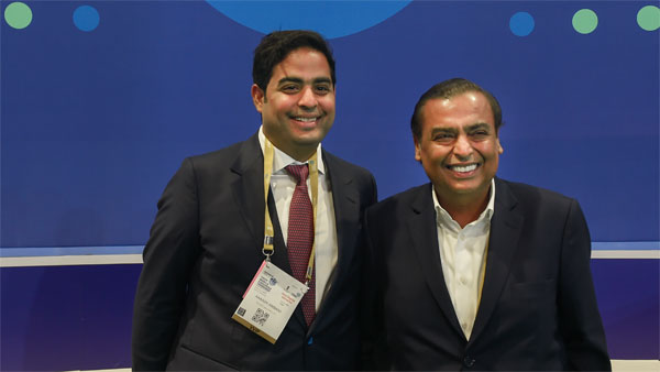 Reliance Industries Ltd Chairman Mukesh Ambani with his son Akash Ambani poses for photographs at Reliance Jios stall during the 6th India Mobile Congress at Pragati Maidan in New Delhi Reliance Industries Ltd Chairman Mukesh Ambani with his son Akash Ambani poses for photographs at Reliance Jios stall during the 6th India Mobile Congress at Pragati Maidan in New Delhi
