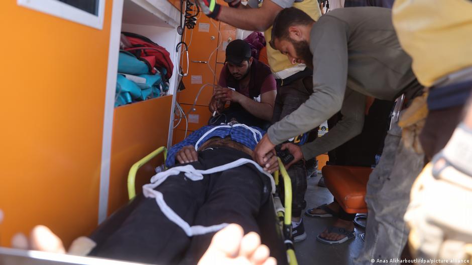 Members of the White Helmets treat an injured person following the airstrike by Russian warplanes in Jisr al-Shughur Members of the White Helmets treat an injured person following the airstrike by Russian warplanes in Jisr al-Shughur