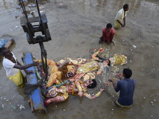 Devotees Immerse An Idol Of Goddess Durga At A Pond In Mayur Vihar, New Delhi