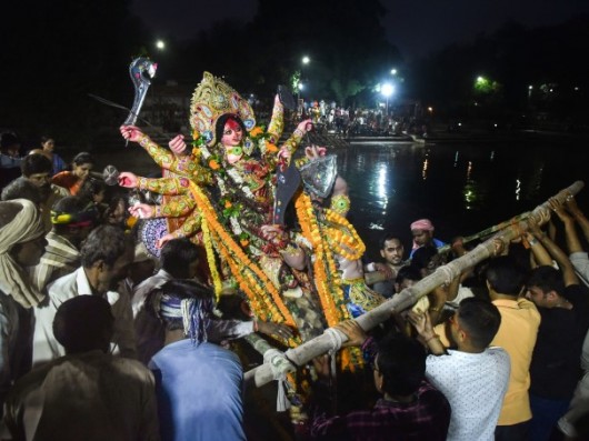 Devotees Immerse An Idol Of Goddess Durga On The Occasion Of Vijayadashami In Varanasi