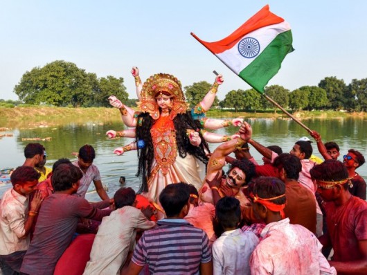 Devotees Immerse An Idol Of Goddess Durga On The Occasion Of Vijayadashami, At A Pond Near Jhusi Vil